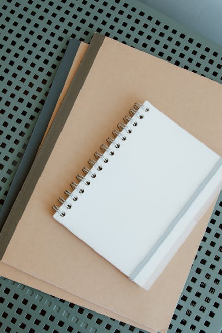 A clean desk with an open journal, a quality pen, and a cup of tea in a minimal planning workspace