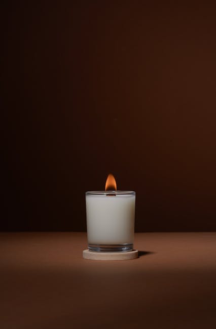 A quiet, warmly lit room with candles and soft textures, prepared for an evening of calm wedding planning